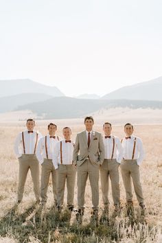 a group of men standing next to each other in a field