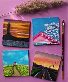 four small paintings are displayed on a purple surface