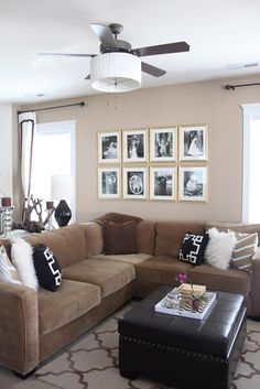 a living room filled with furniture and pictures on the wall