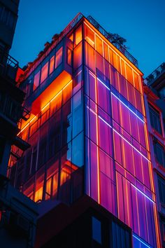 A sleek, modern hotel with neon lights illuminating the facade, offering a bold, futuristic design.