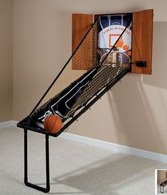 a basketball is in the backboard of a wall mounted basketball hoop that holds a basketball