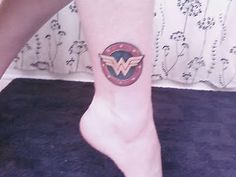 a woman's foot with a tattoo on it and a bird in the center