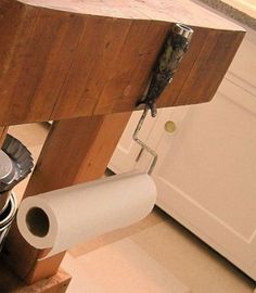 a kitchen counter with two buckets and a roll of toilet paper on the bottom