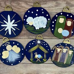 six hand painted christmas ornaments hanging on a wooden wall