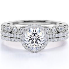 a white gold engagement ring set with a round brilliant diamond center surrounded by pave diamonds