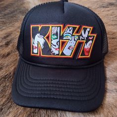 Espy Threads Original Kiss Snapback Trucker Hat With Embroidered Patch. Black Fun Snapback Hat With Curved Brim, Black Festival Hat, One Size, Black Festival Hat One Size Fits Most, Black Festival Hat, Fun Black Adjustable Snapback Hat, Vintage Black Trucker Hat For Summer, Black Retro Brimmed Hat, Black Brimmed Retro Hat, Fun Black Snapback Hat With Flat Brim