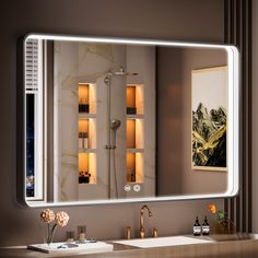 a bathroom with a large mirror and lights on the wall next to it's sink