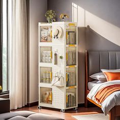 a room with a bed and a white bookcase filled with lots of books next to a window