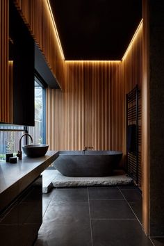 a bath room with a large tub and a sink