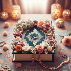 an open book sitting on top of a table covered in flowers and pearls next to candles