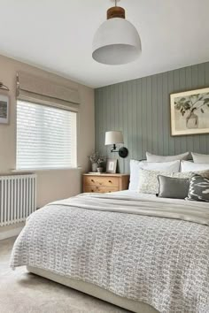 a bedroom with grey walls and white bedding