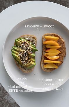 two pieces of bread on a plate with different toppings and fruit cut in half