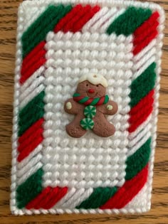 a knitted christmas ornament with a teddy bear on it