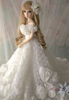 a doll is dressed in a white wedding dress