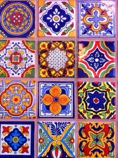 many colorful tiles are arranged on the wall