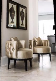 a living room with two chairs and a piano in the back ground, one chair has gold upholstered fabric on it