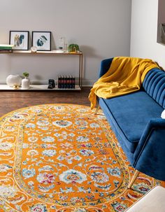 a living room with a blue couch and yellow rug