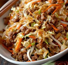 a white bowl filled with meat and veggies