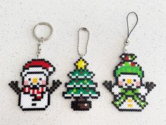 three christmas themed key chains on a white surface