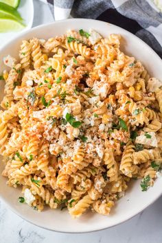 a white bowl filled with pasta and cheese