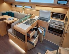 the interior of a boat with an oven, sink and stove top in it's center