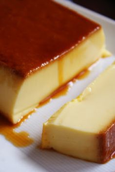 two pieces of cheesecake sitting on top of a white plate covered in caramel sauce