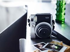 a camera sitting on top of a table next to pictures