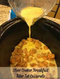 slow cooker breakfast tater tot casserole is being poured into the crock pot