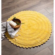 a yellow rug is on the floor next to a bowl