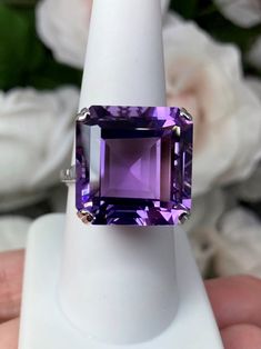 Natural Purple Amethyst RingE-Ring Design#D1 This is a beautiful vintage reproduction ring. The sterling silver filigree holds an ~20 carat natural purple amethyst gemstone. The amethyst stone has perfect purple grape color and amazing clarity. The flawless high quality square-cut gemstone is 18mm square. The stone and setting rise about 1/2" off the finger. The inside of the band is marked 925 for sterling silver. Notice the beautiful crisscross basket pattern in the silver filigree setting. Th Grape Color, Basket Pattern, Purple Amethyst Ring, Purple Grapes, Amethyst Gem, Purple Band, Sterling Silver Filigree, Square Cut, February Birth Stone