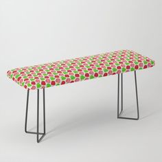 an upholstered bench with red, green and pink apples on the seat cover