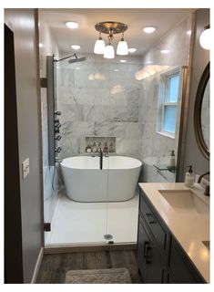 a white bath tub sitting inside of a bathroom