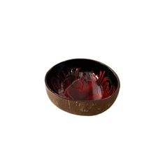 a bowl filled with red fruit on top of a white background