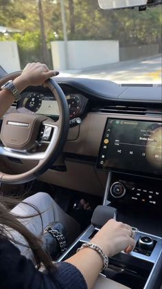 a woman driving a car with the screen on