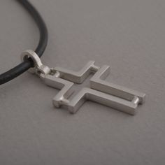 Minimal line and ingenious design characterize this beautiful sterling silver cross pendant necklace for men or women. The effect is minimalistic, yet alluring. Suspended from a silver chain or leather cord with silver clasp and endings, it is a stylish accessory for anyone that wants to keep their faith close to their heart and share it for the world to see. This also makes a stunning Christian gift for a special person in your life. Cross measures 3.8 cm x 2 cm. You get the cross with a 48 cm Mens Cross Necklace, Sterling Silver Cross Pendant, Mens Crosses, Silver Cross Pendant, Necklace For Men, Sterling Silver Cross, Religious Jewelry, Cross Pendant Necklace, Necklace Sterling Silver