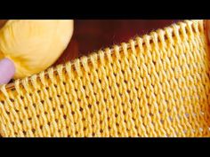 someone is stitching the side of a yellow piece of fabric