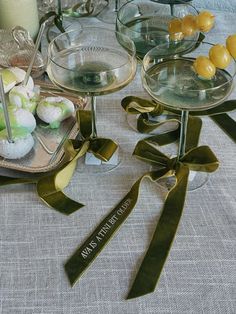 there are many desserts on the table with ribbons around them, including lemons