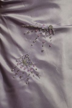 "This new gown is a light lilac, not the strong color shown in one picture. Look at the 3rd picture for the color. It is listed as a size 12, however it has some size 10 measurements. They are: b 37\" w 28\" h 39.5.\" This gown is not fully pressed because I accidently touched the gown, with the iron, while steaming it. This left 2 small, darker spots on the fabric, which I have covered with beads and crystals. The beading can be seen in the last picture. It is located on the right side of the g Embellished Purple Evening Dress For Wedding, Lavender Evening Dress For Wedding And Prom Season, Lavender Evening Dress For Wedding And Prom, Elegant Lavender Gown With Sweetheart Neckline, Lavender Gown With Sweetheart Neckline For Wedding, Pink Rhinestone Wedding Gown, Elegant Purple Gown For Debutante Ball, Elegant Wedding Dress For Prom Season, Elegant Pink Pageant Wedding Dress