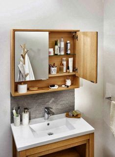 a bathroom with a sink, mirror and towel rack in the corner on the wall