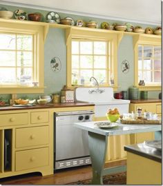 a kitchen filled with lots of yellow cabinets and counter top space next to a white stove top oven