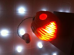 a lighted pumpkin on top of a table