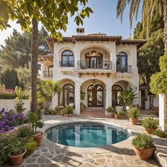 a house with a pool in front of it and lots of plants around the pool