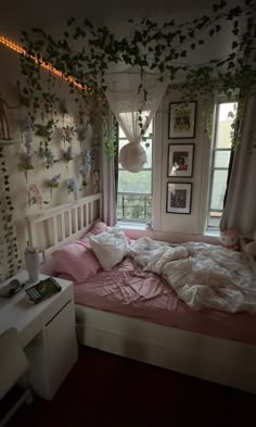 an unmade bed in a bedroom with plants growing on the walls and windows above it