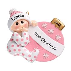 a baby's first christmas ornament hanging on a pink background