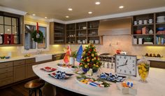 a kitchen with a clock on the wall next to a white counter top covered in plates and bowls