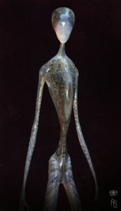 a silver statue is standing in the dark