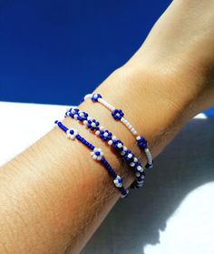 Hand made jewelery made of high quality Japanese glass beads, silon and elastic cord and steel clasp.  There are bracelets in 5 sizes:  - 14cm/ 5,5 inch  - 15,5cm/ 6,1 inch  - 17cm/ 6,7 inch  - 18,5cm/ 7,3 inch  - 20cm/ 7,9 inch Bracelet number 1 has a silon cord and steel clasp. Bracelets number 2 and 3 have an elastic cord. Blue Flower Beaded Bracelets For Summer, Adjustable Blue Beaded Bracelets 8mm, Handmade Blue Flower Beaded Bracelets, Adjustable Blue Beaded Bracelets Ocean-inspired, Blue Flower-shaped Beaded Jewelry, Casual Blue Flower-shaped Beaded Bracelets, Beaded Braclets, Beaded Flowers, Blue Sky