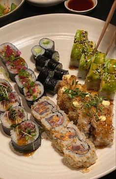 a white plate topped with different types of sushi