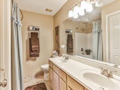 a bathroom with two sinks and a large mirror