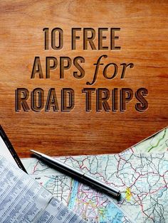 a wooden sign with the words 10 free apps for road trips on it and a map next to it